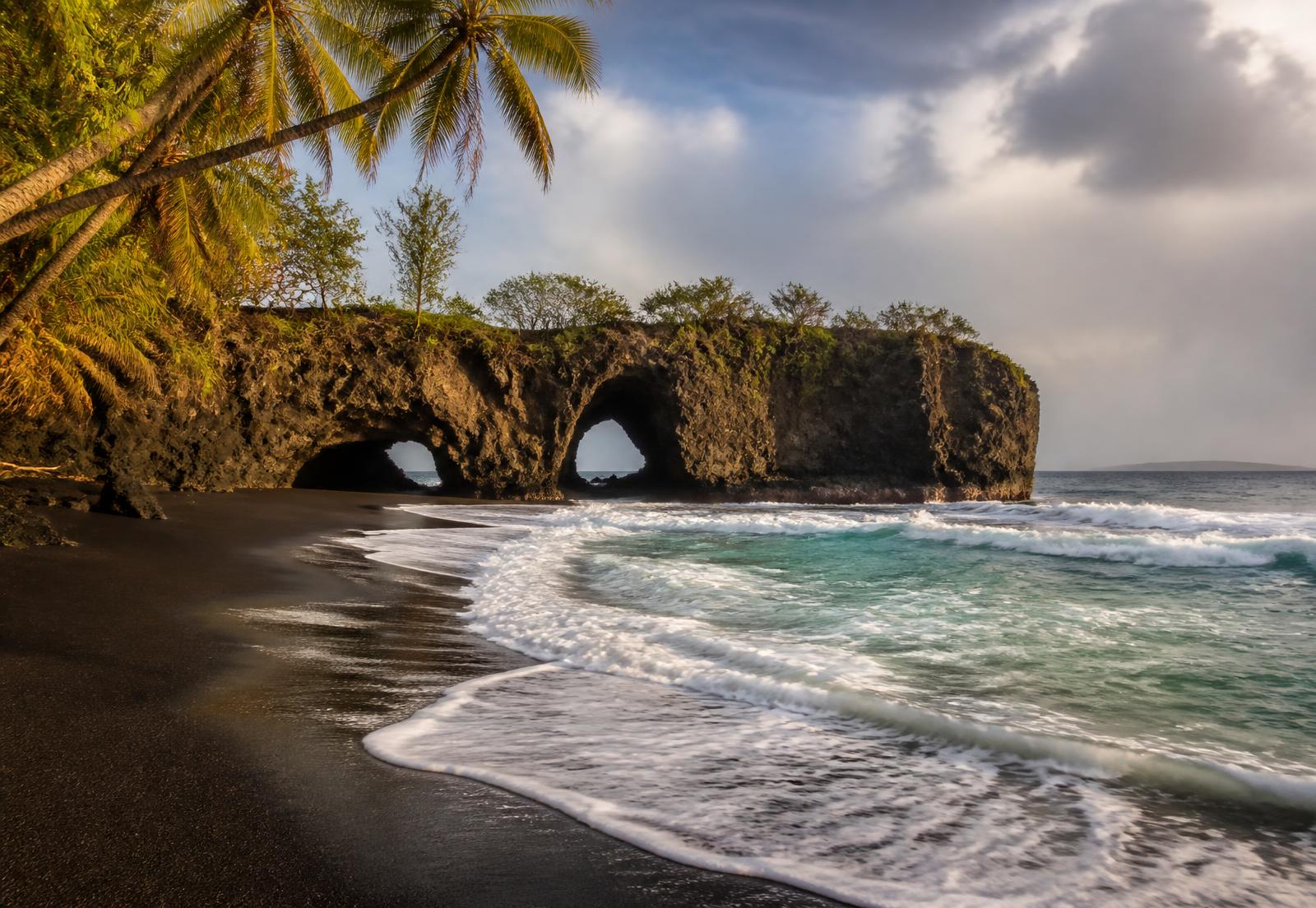 Cuevas marinas y arena oscura en Playa Ventanas, Costa Ballena, Costa Rica